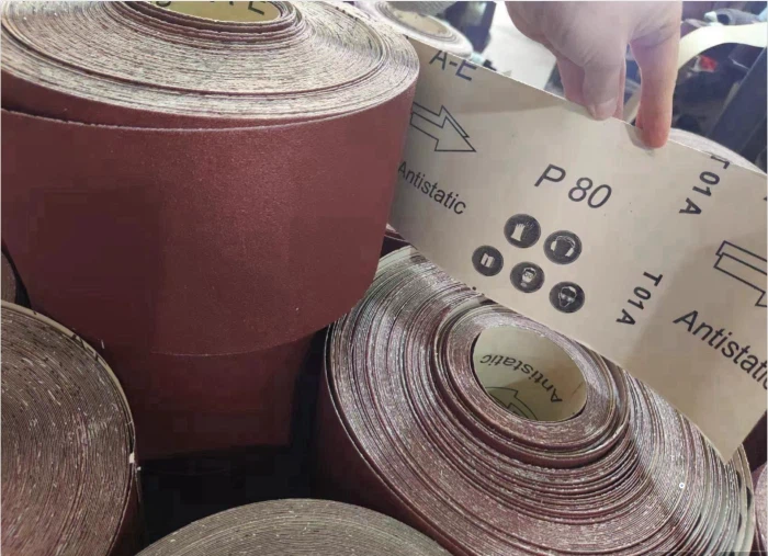 How is the hardness of sandpaper defined? What factors are related to it?