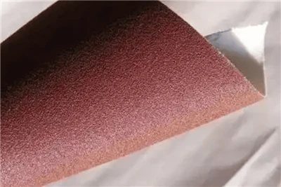 What improvements can the treatment on the back of sandpaper (such as anti-sl...